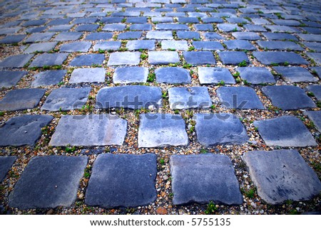Background of cobblestone pavement with light reflection