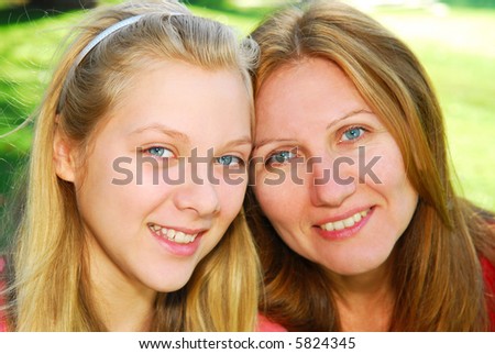 Portrait of mother and daughter in summer park