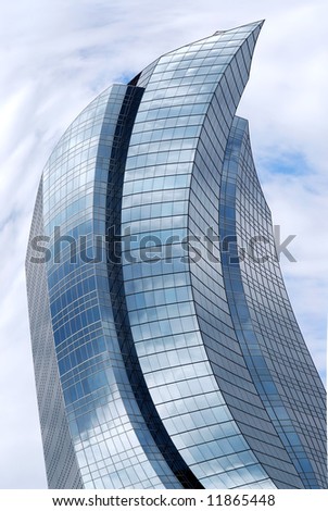 Distorted futuristic corporate building with glass walls reflecting clouds