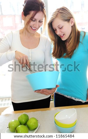 Mother and daughter cooking together at home