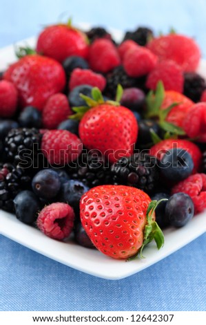 Assorted fresh berries on a plate close up