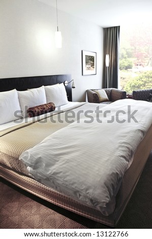 Bedroom with comfortable bed in neutral colors