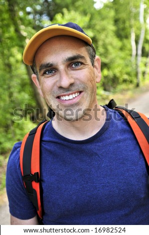 Portrait of happy middle aged man on a forest trail