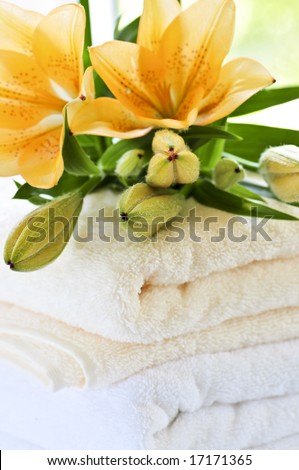 Stack of soft luxury towels with fresh flowers