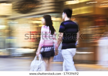 stock photo Couple shopping in a mall panning shot intentional incamera