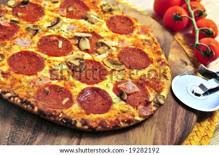 Freshly baked pepperoni pizza on wooden board