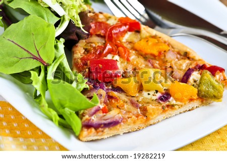 Vegetarian meal of vegetable pizza and green salad