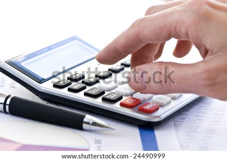 Typing  numbers for income tax return with pen and calculator