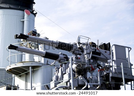 Large white guns on a military naval vessel