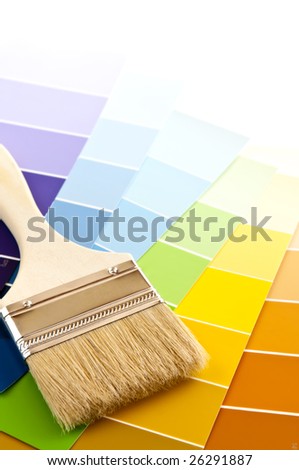Clean paintbrush on rainbow of color card samples
