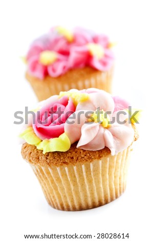 Row of tasty cupcakes with icing flowers