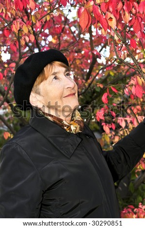 Senior woman looking up in fall park