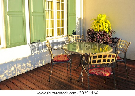 Patio chairs and tables on wooden patio deck