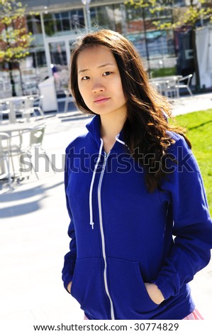 Young korean woman at outdoor mall in blue hoodie