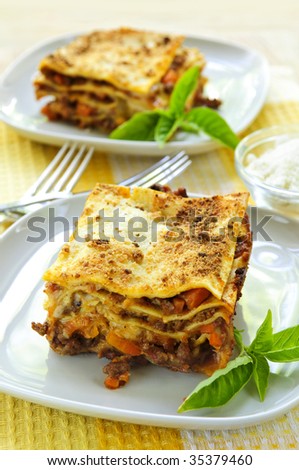 Two servings of fresh baked lasagna on plates