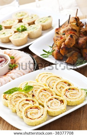 Many dishes of bite size appetizers and party food