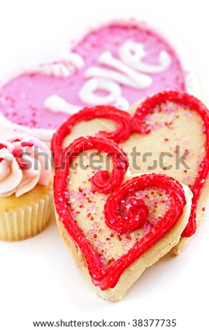 Homemade baked shortbread Valentine cookies and cupcake with icing on white background
