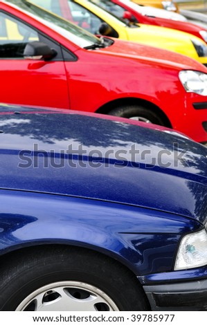 stock photo Row of cars in parking lot on a bright day