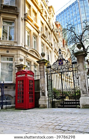 Red telephone box near old and new buildings in London