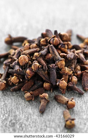 Several dried clove buds on wooden background