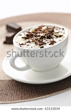 Cup of hot cocoa with shaved chocolate and whipped cream