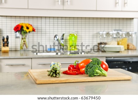 Modern kitchen interior with fresh vegetables on natural stone countertop Modern kitchen interior with fresh vegetables on natural stone countertop