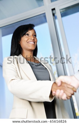 Portrait of black business woman shaking hands