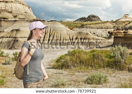 Girl enjoying scenic view at the Badlands in Dinosaur provincial park, Alberta, Canada