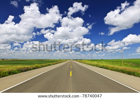 Long stretch of flat highway in Saskatchewan prairies, Canada