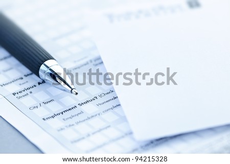 Blank credit application form with envelope and pen close up