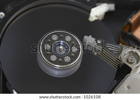 Macro shot of the computer hard drive internal plates and the head