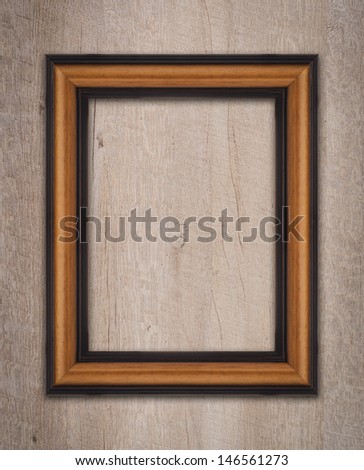 Vintage wooden frame on a wood made wall.