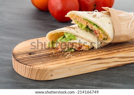 Tortillas with chicken and vegetables, on chalk board table.
