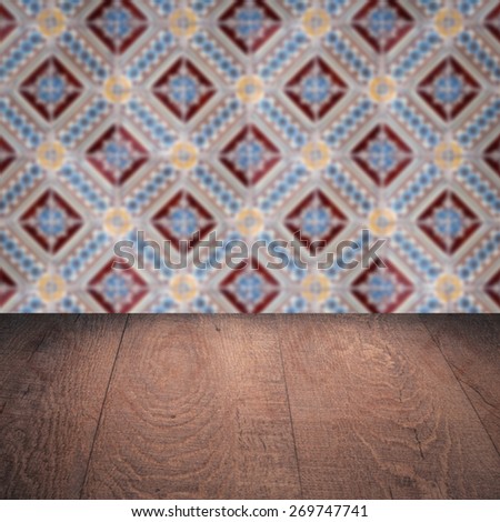 Empty wood table top and blur vintage ceramic tile pattern wall in background, Mock up template for display of your product.