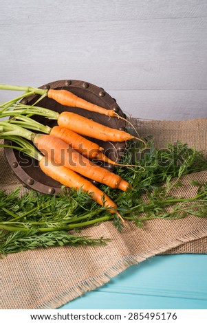 Carrots on a turquoise blue wooden table. Vintage Style.