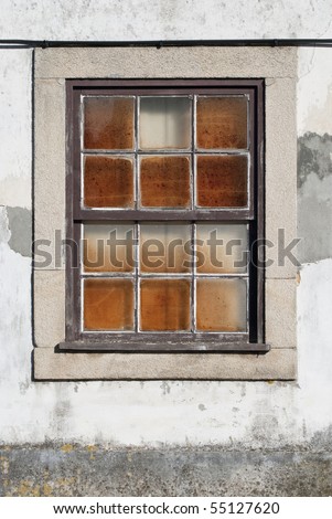 A closed old window with dirty glass.