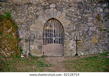 Old medieval castle gate in a fortified granite wall.