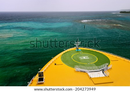 helicopter landing pad on a large ship in caribbean waters