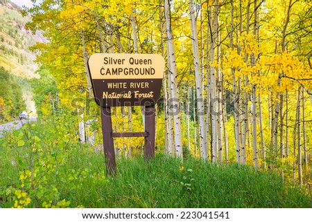 entrance sign to Silver Queen campground in Colorado amidst colorful aspens of autumn