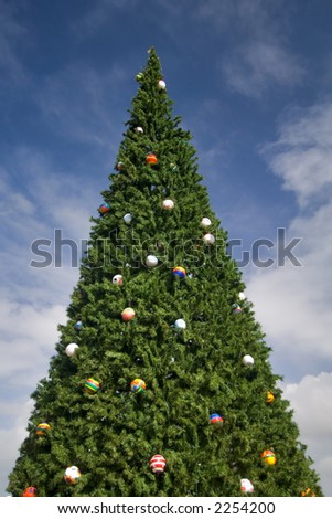 community christmas tree in florida keys, buoys as ornaments,  against blue sky with fluffy clouds