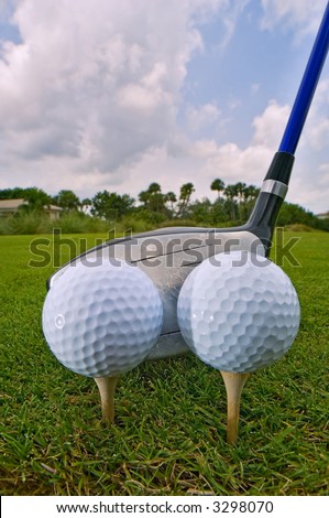 two golf balls teed for one drive for efficiency