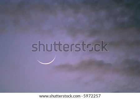 sliver of the moon at dawn as background