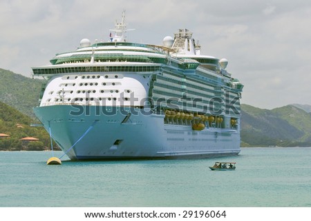 huge cruise ship anchored in caribbean harbor
