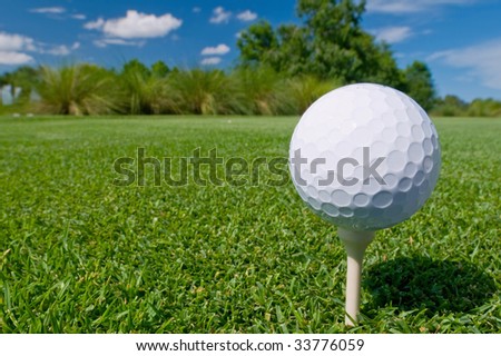 golf ball on tee with deep blue sky above
