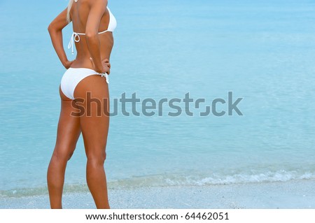 stock photo lovely tanned female blonde bikini model standing beside ocean