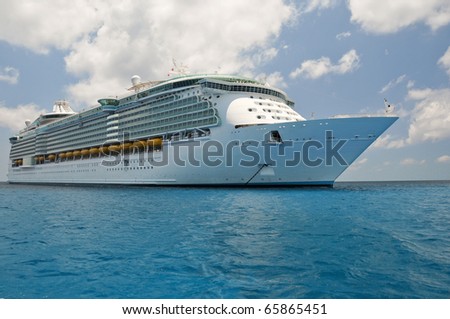 huge luxury cruise ship anchored in blue caribbean waters