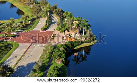aerial view of road and lake in south florida suburban community with copy space