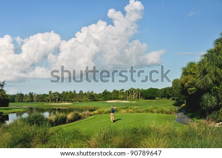 golfers tee off at golf course in the morning