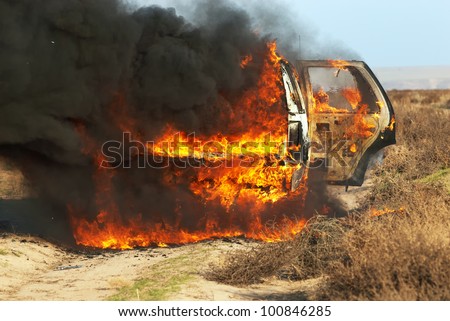 Car fire on desert rural road