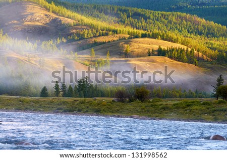 Morning fog on river Shishged in northern Mongolia